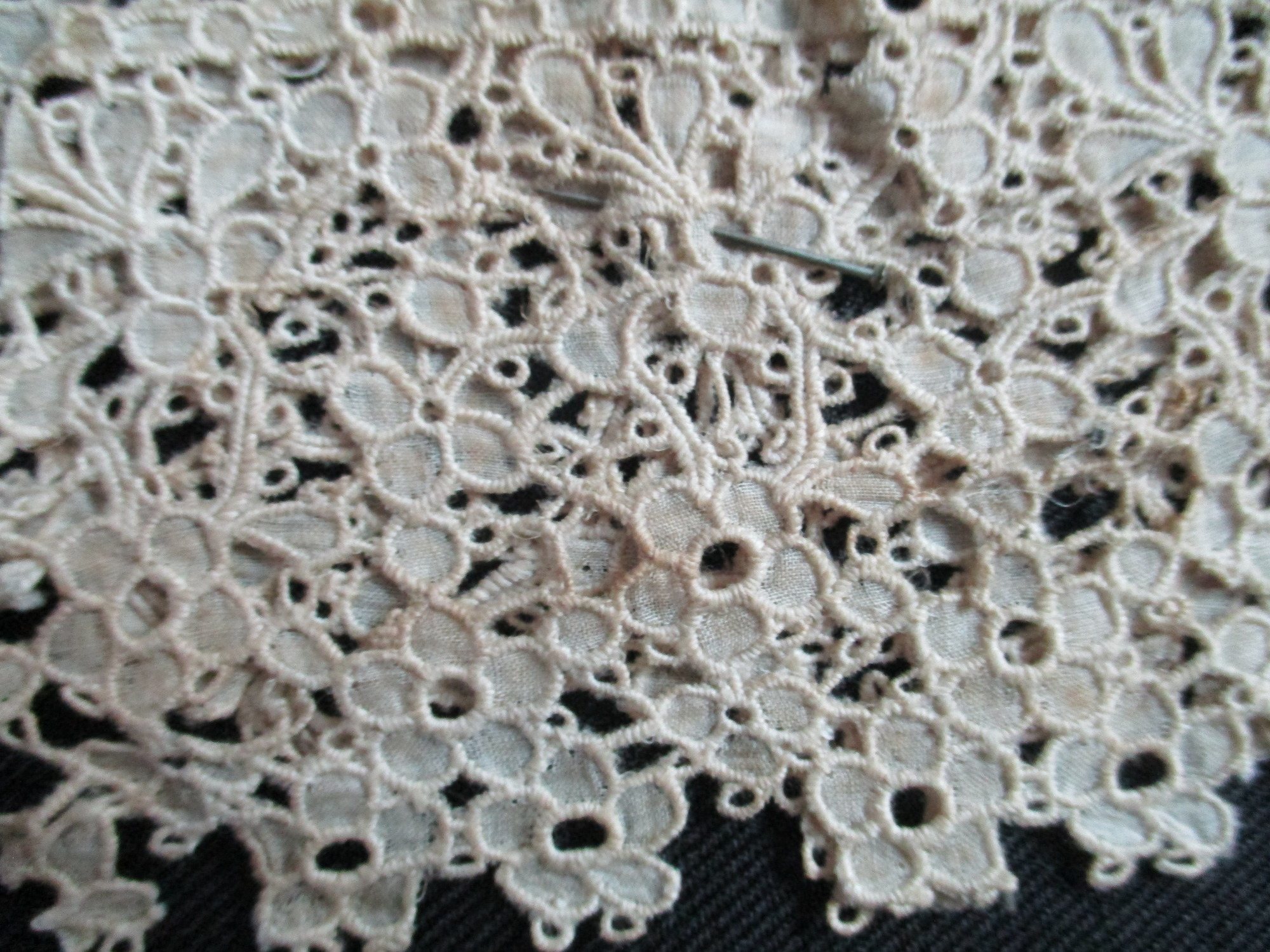 2 pieces of silk lace.: Cream silk lace with steel pin.