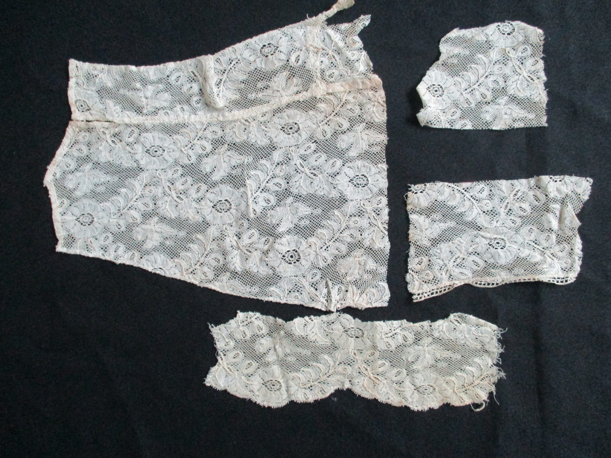 Four pieces of cream lace.