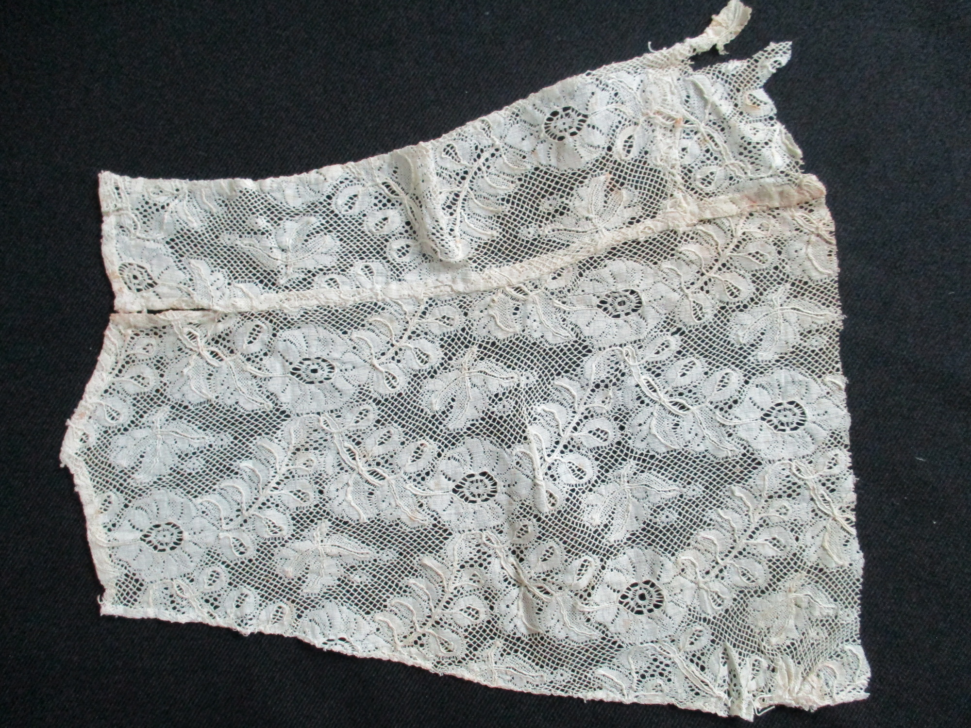 Four pieces of cream lace.: Large piece of cream silk lace cut from a collar.