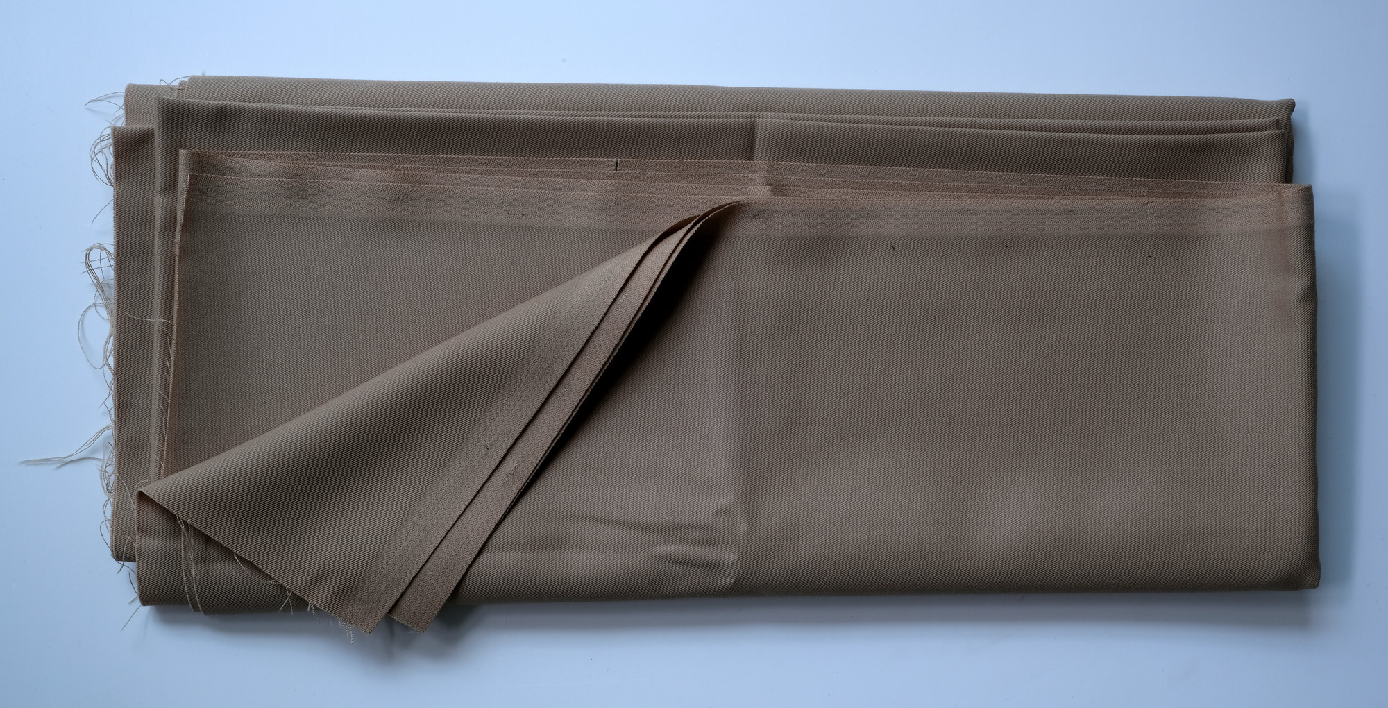 Length of beige cloth: View showing cloth folded back once