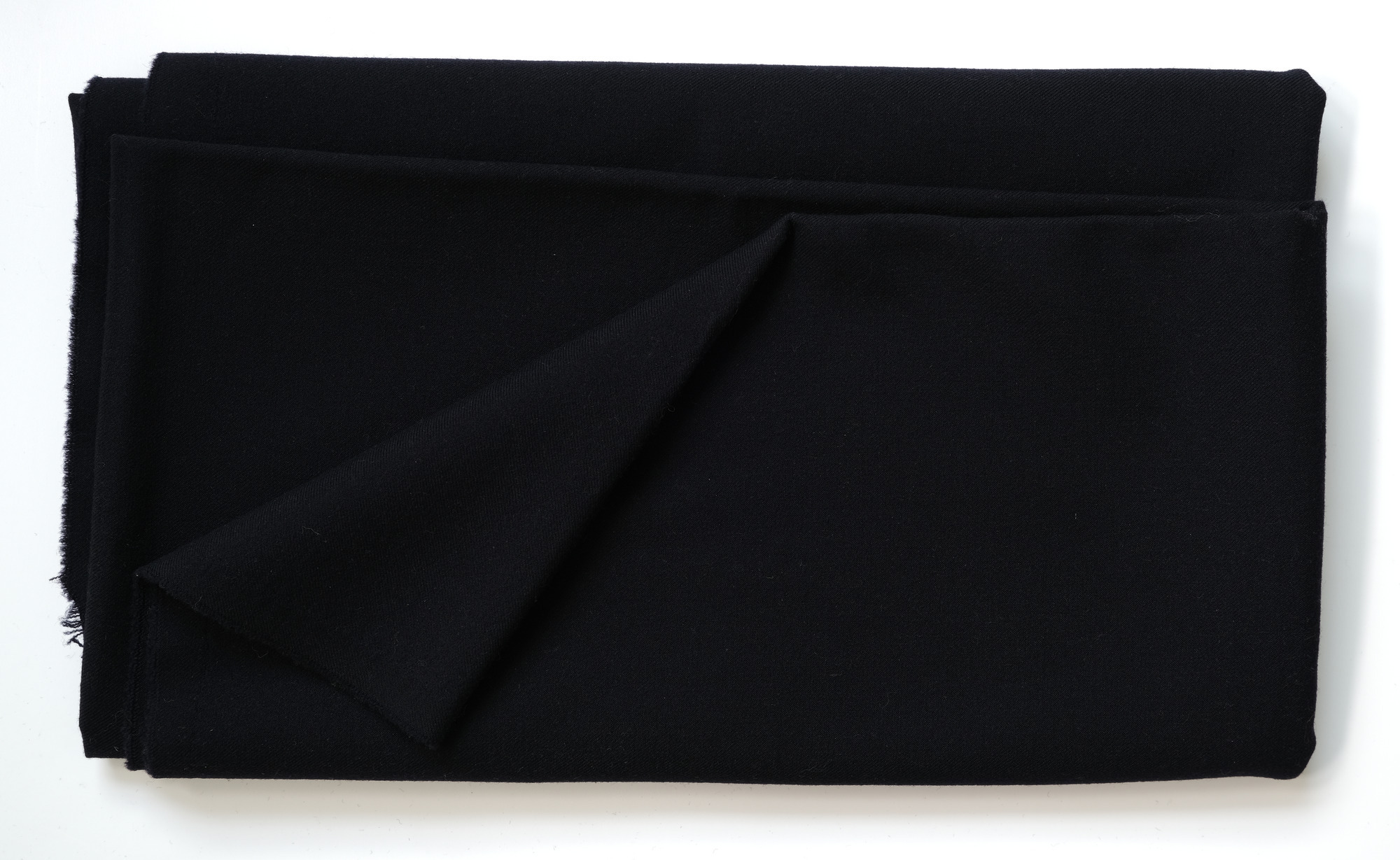 Length of dark blue or black cloth: View showing cloth folded back once