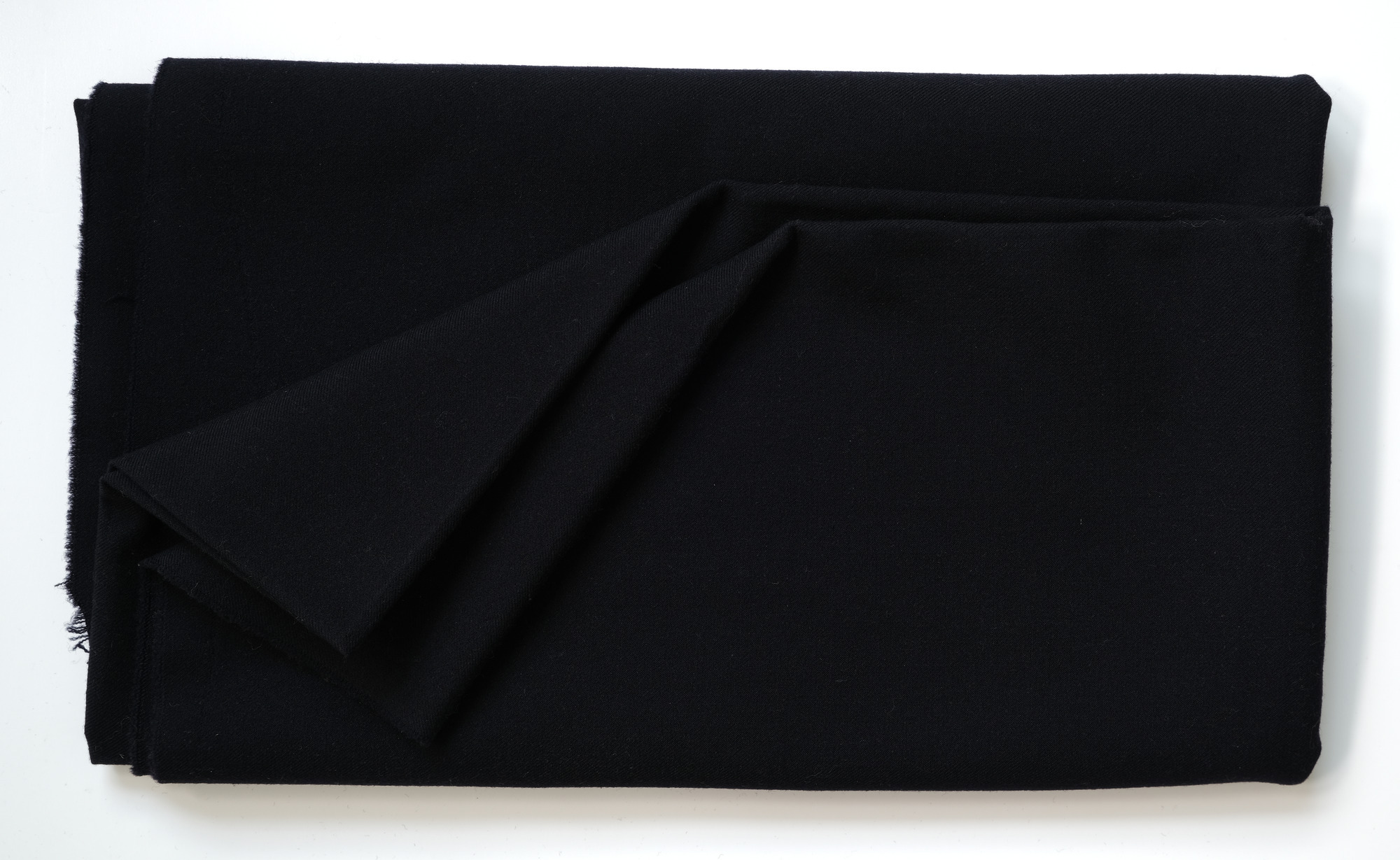 Length of dark blue or black cloth: View showing cloth folded back once