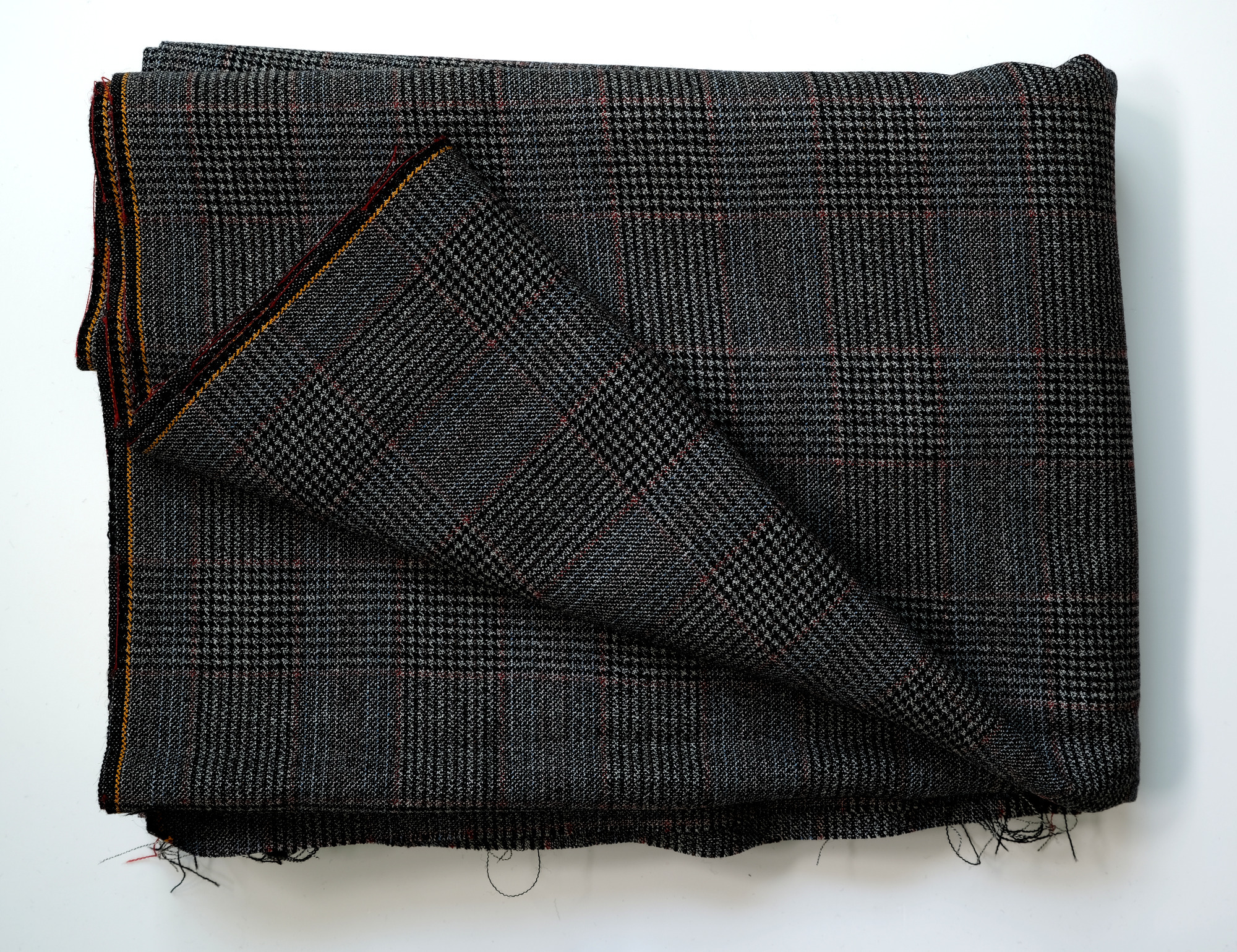 Length of dark grey, dogtooth-pattern cloth: View showing cloth folded back once