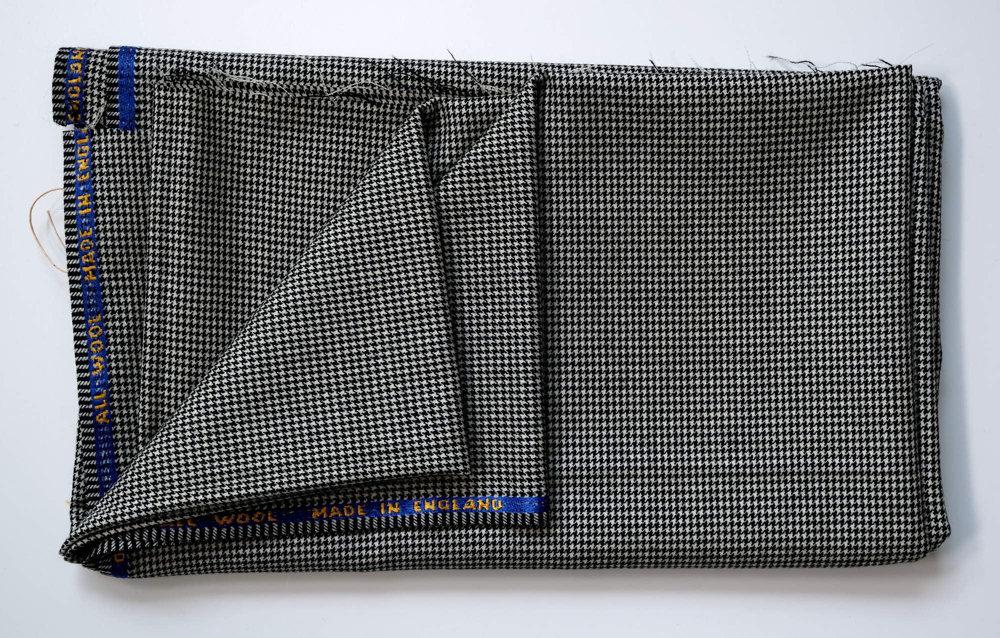 Length of dogtooth-pattern all-wool cloth: View showing cloth folded back twice