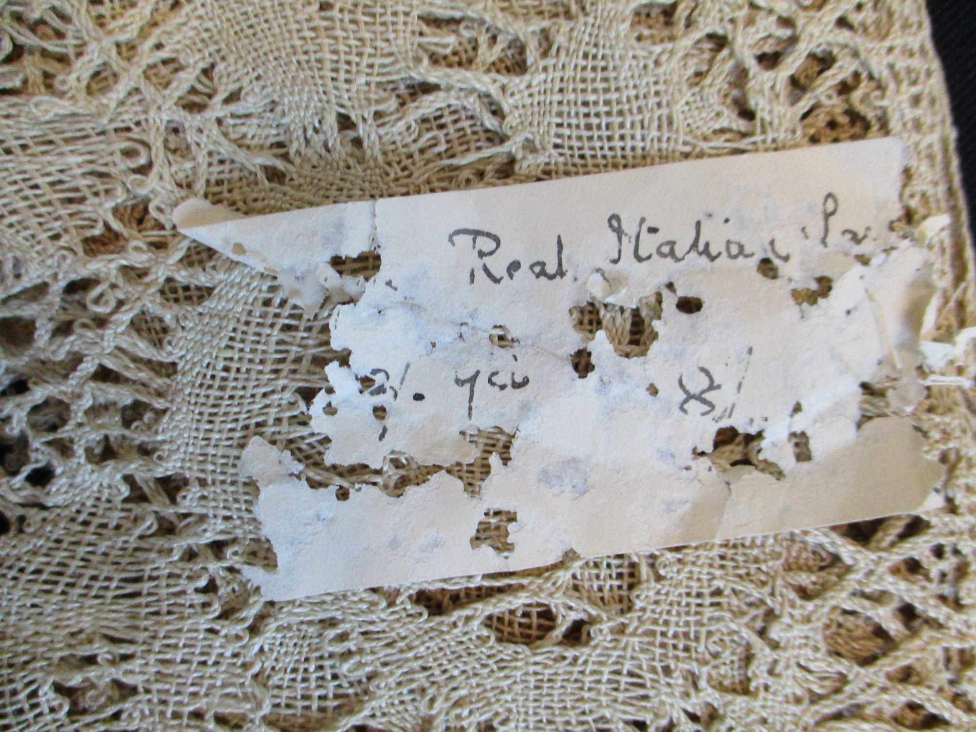 Length of Italian lace with sales ticket.: Sales label on Italian lace.