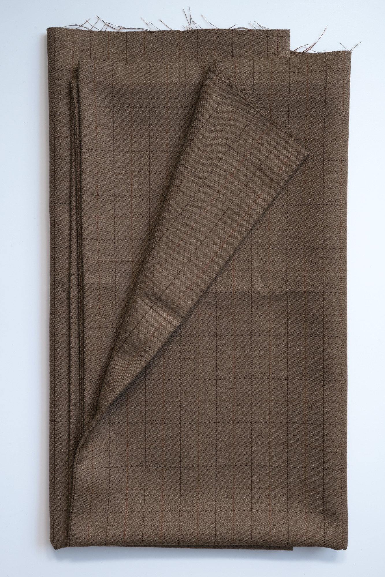 Length of light-brown slight-check cloth: View showing cloth folded back once
