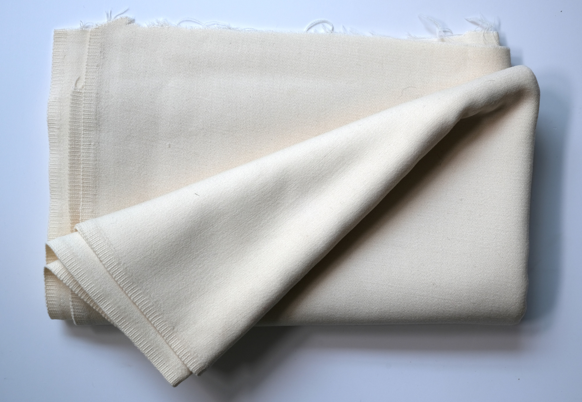 Length of white cloth: View showing cloth folded back once