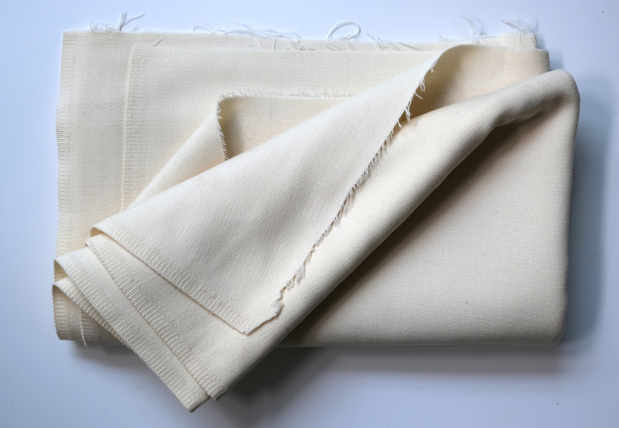 Length of white cloth: View showing cloth folded back thrice