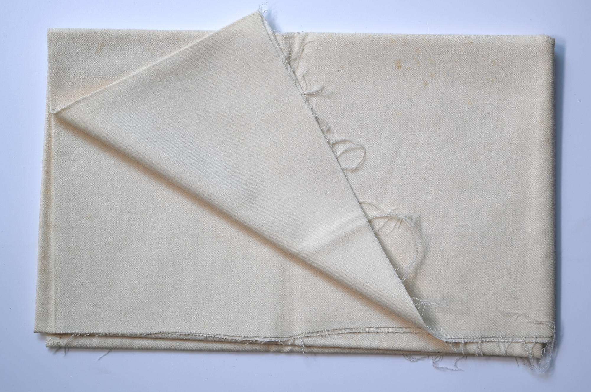 Length of white cloth: View showing cloth folded back once