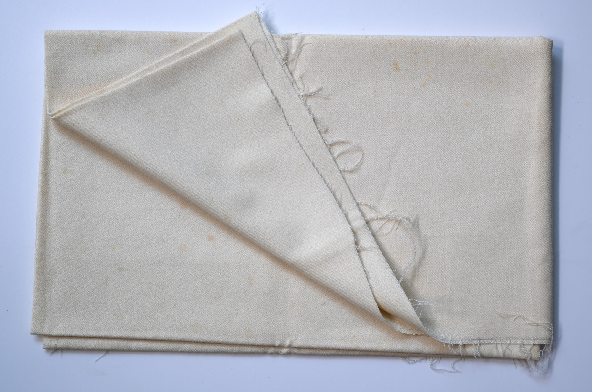 Length of white cloth: View showing cloth folded back twice