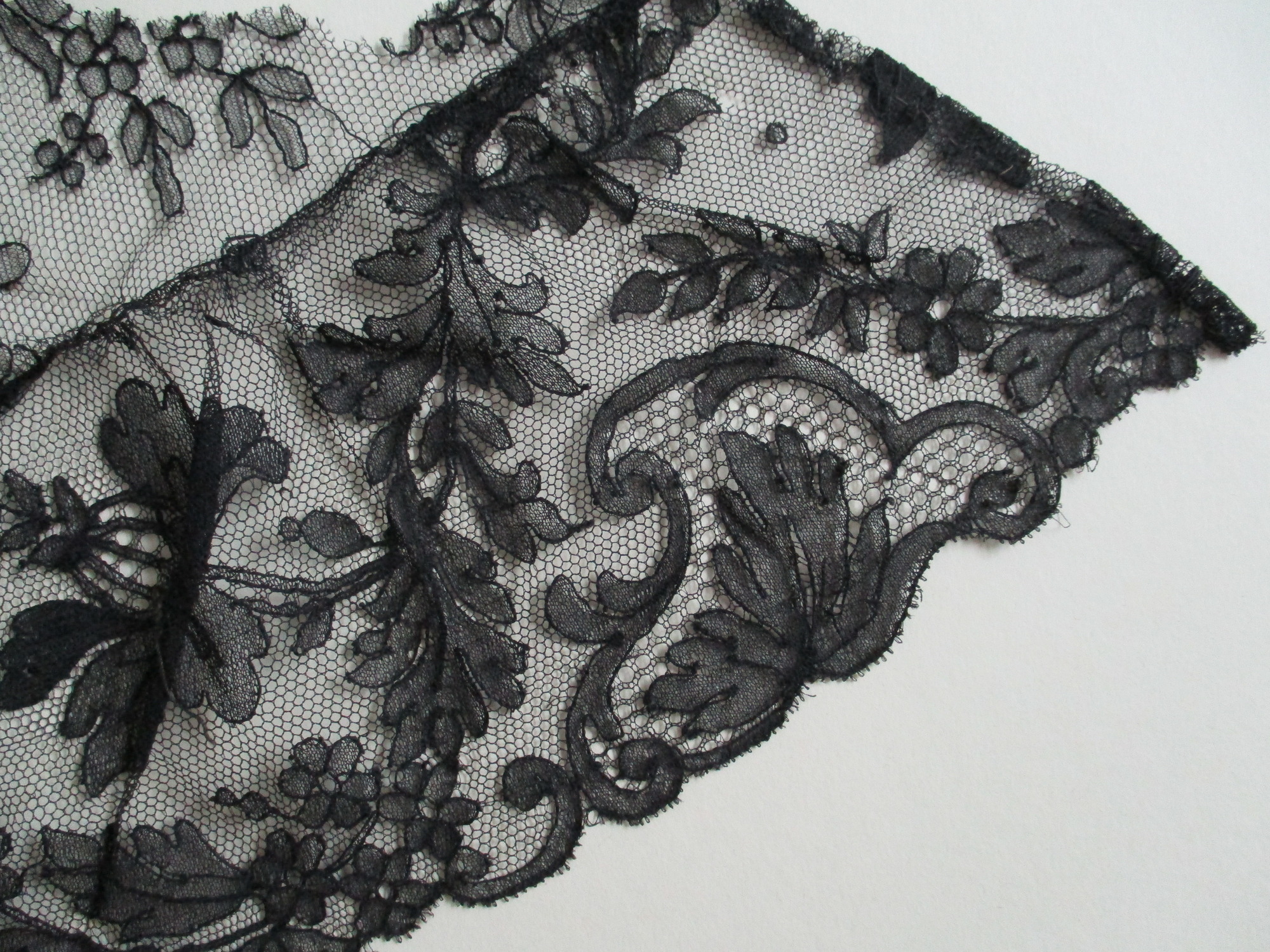 Piece of black lace netting: Black lace netting edge detail 1