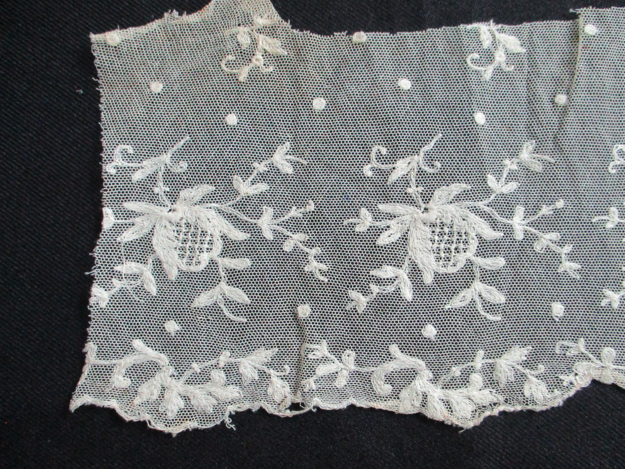 Piece of cream silk embroidered netting.: Close up of lace netting showing embroidered design. (ii)