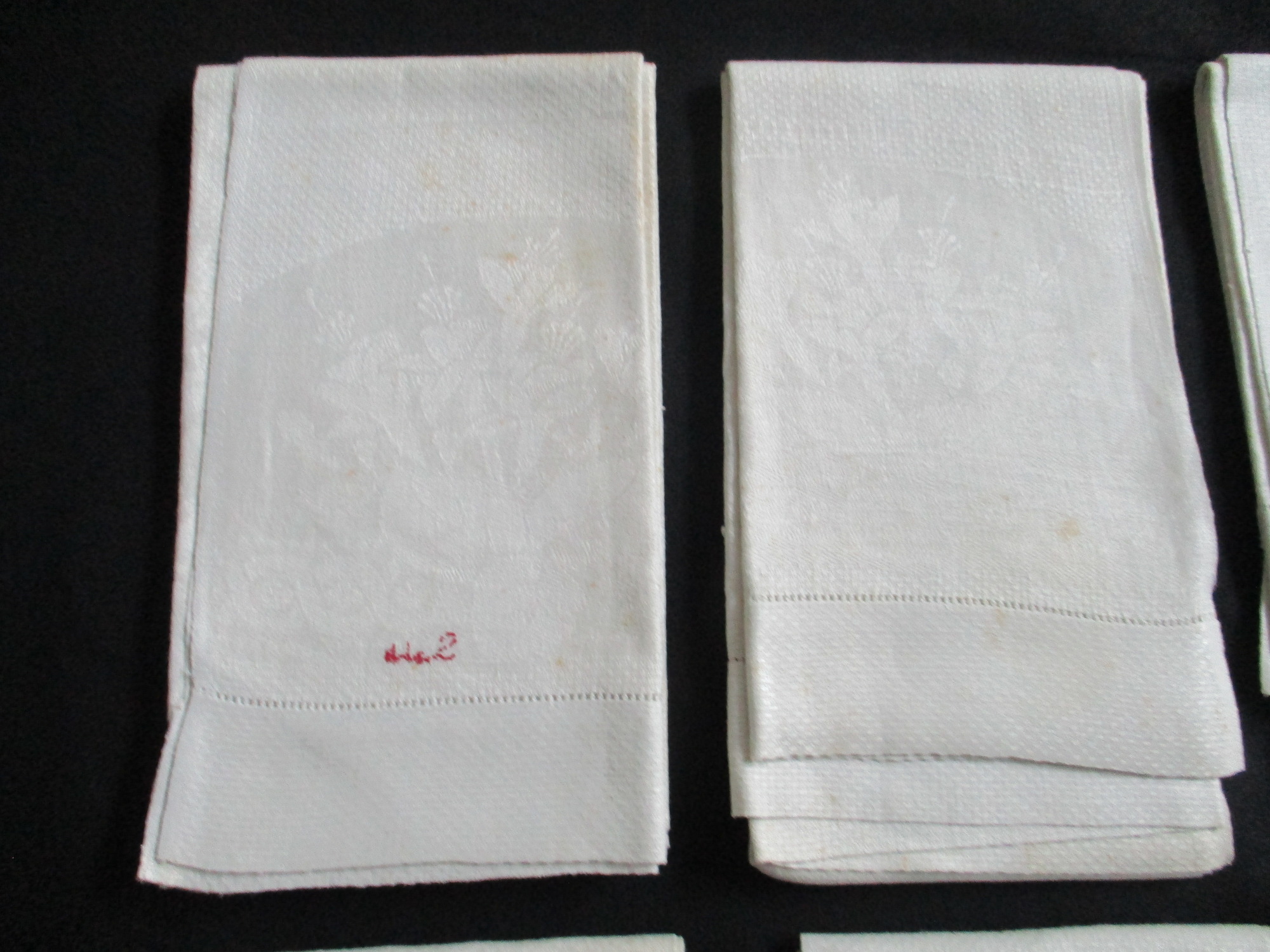 Seven cream damask towels.: Two towels, rear view, one showing reverse of Salt monogram