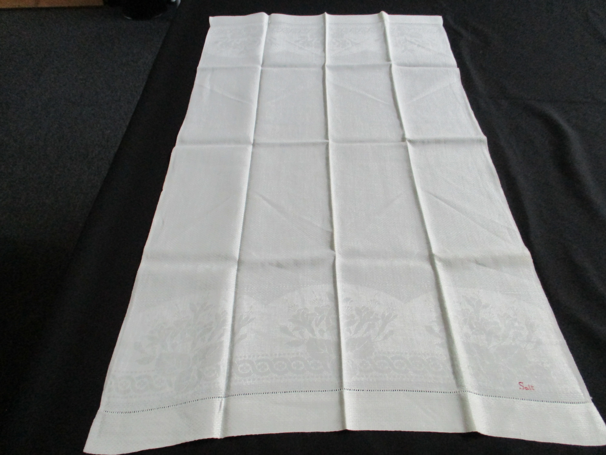 Seven cream damask towels.: One towel fully unfolded