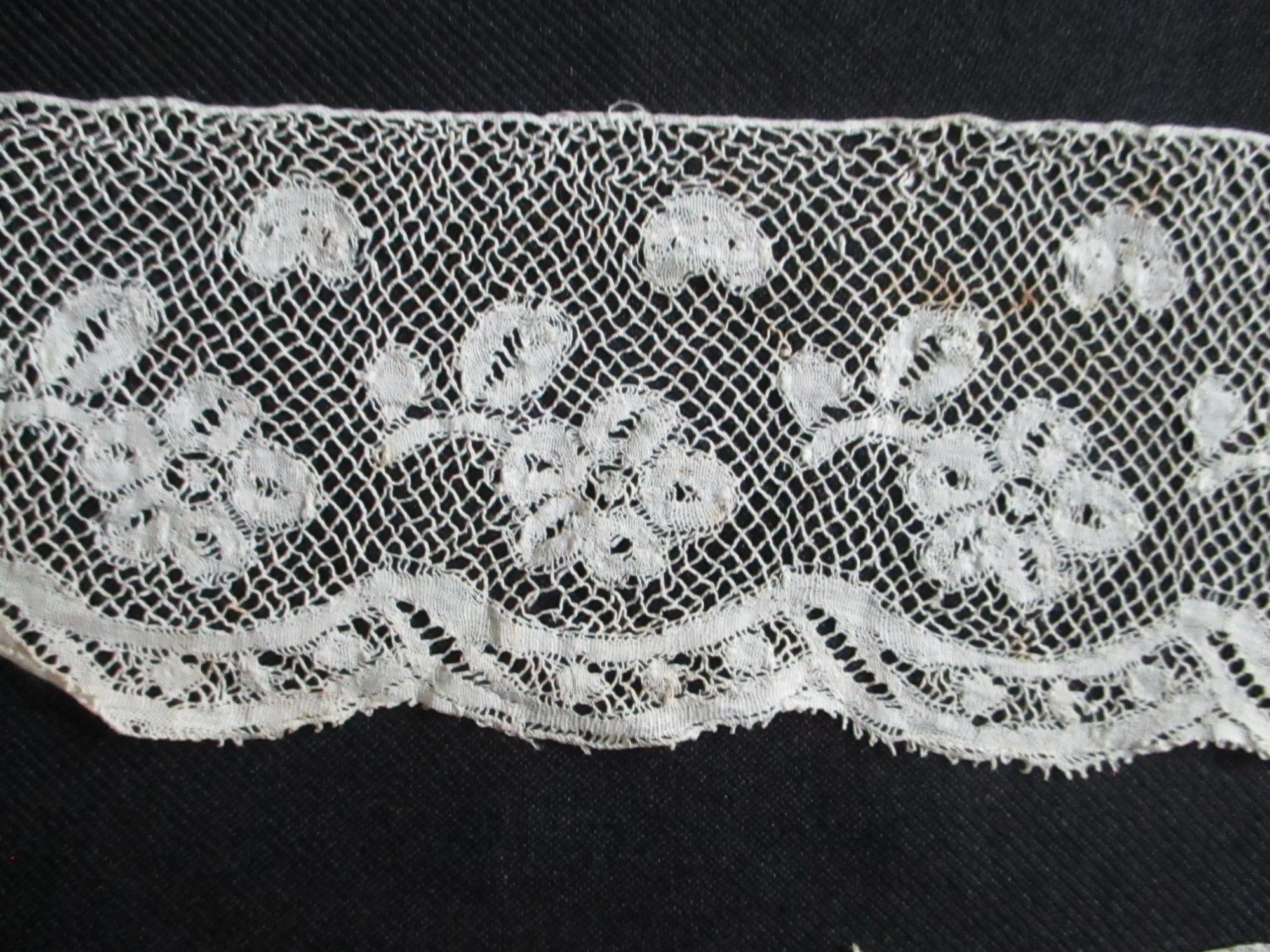 Three pieces of cream silk lace trim.: Close-up image of design detail on cream silk lace trim. (ii)