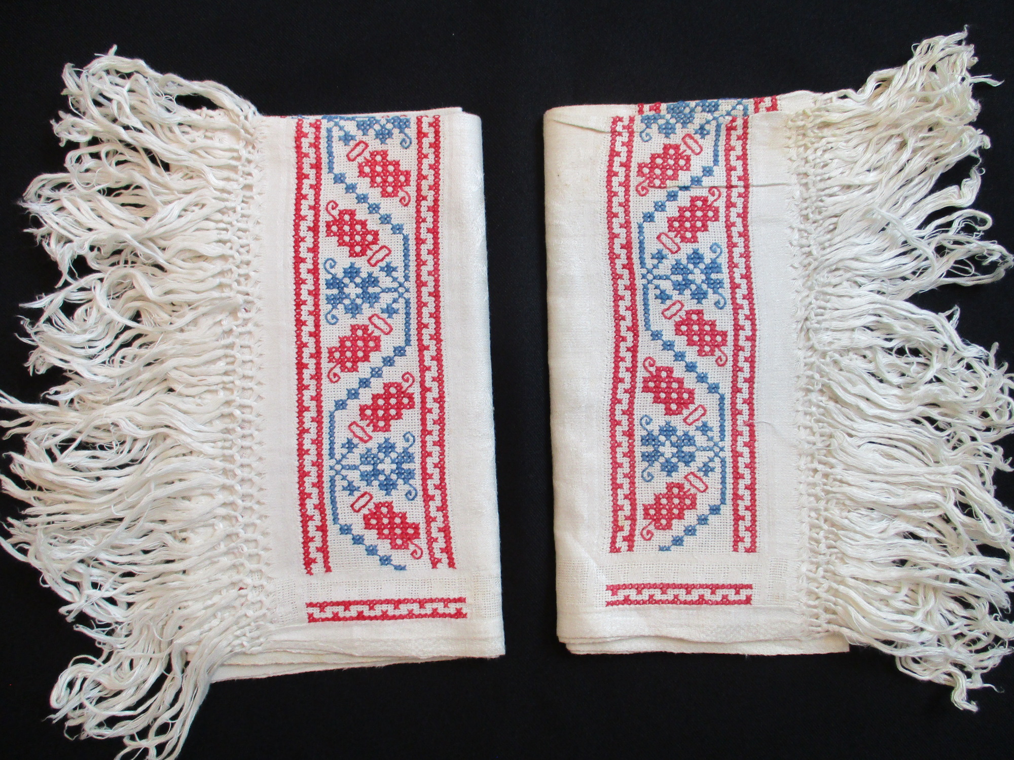 Two fringed towels: Two embroidered fringed towels.