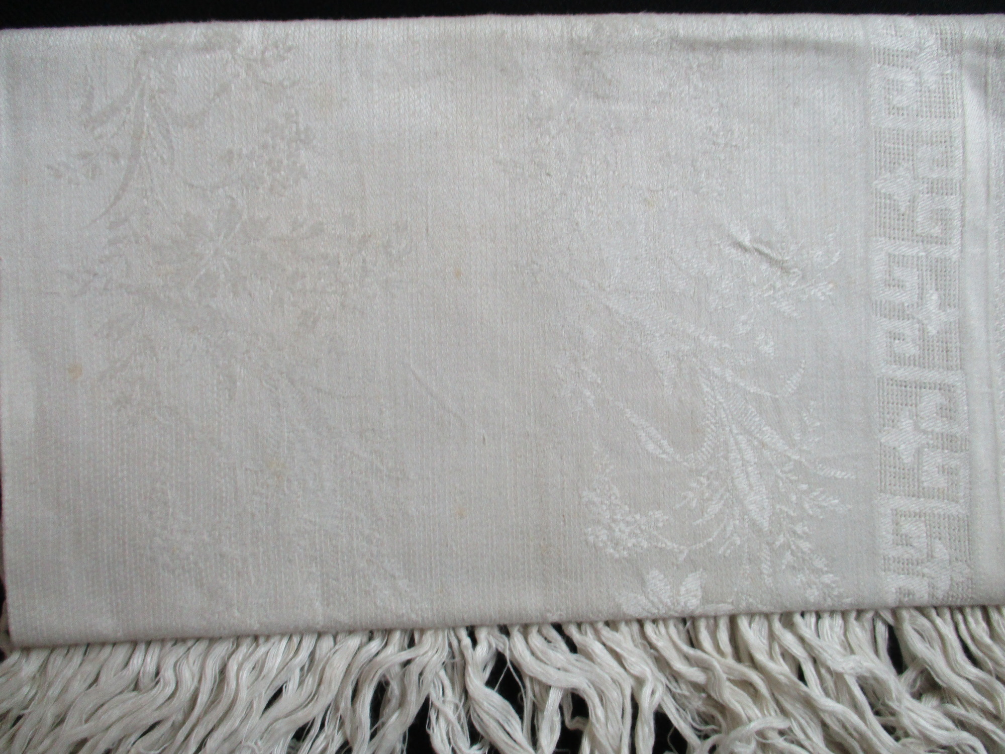 Two fringed towels: Close-up of design on damask towels.