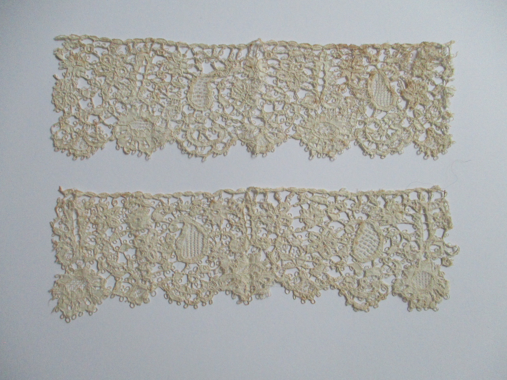 Two pieces of cream silk lace.